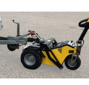 Operator using Alitrak TT-Plus Electric Tug for industrial trailer handling