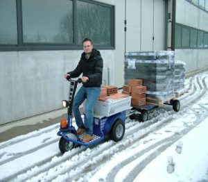 Industrial tug towing carts using Zallys electric tow tractor